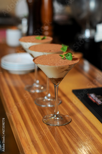 tiramisu desserts in glasses on the bar counter