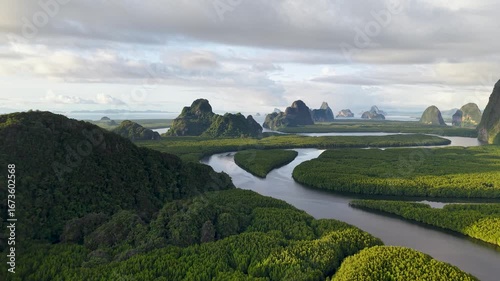 The serene and majestic landscape with its rugged, ancient rock formations. River courses through the lush, vibrant forest.