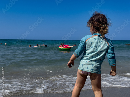 Adorable toddler in rash gu...