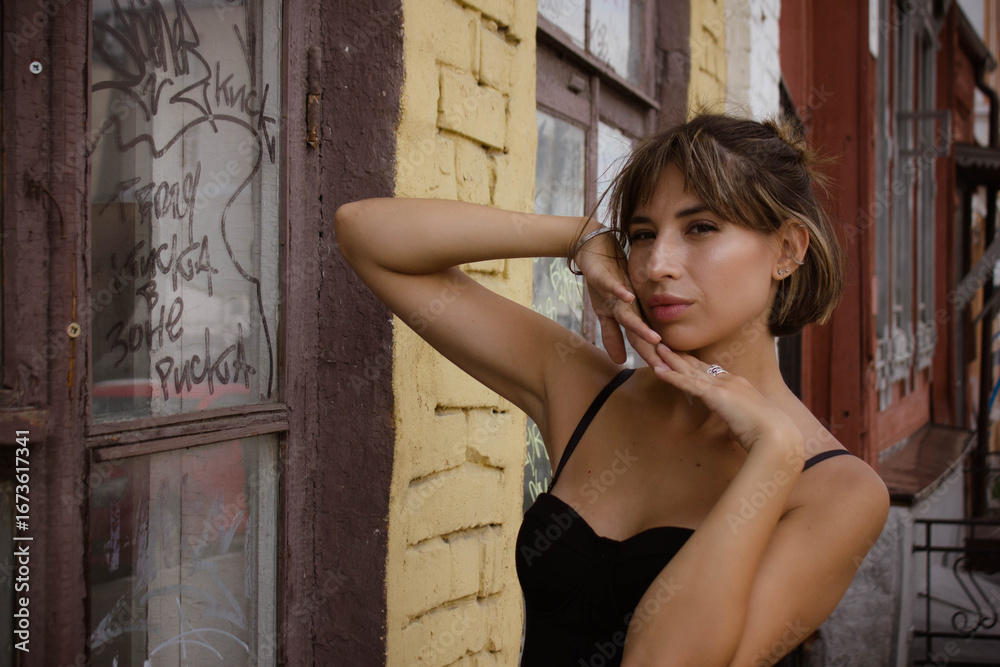 Fototapeta premium portrait of a young brunette woman in a black dress