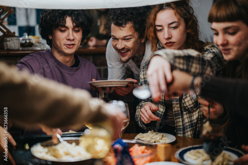 Fototapet A cheerful gathering of friends sharing delicious food and warm moments around a dining table indoors