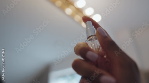 Close Up of Latina Woman's Hands Applying Perfume During Beauty Routine