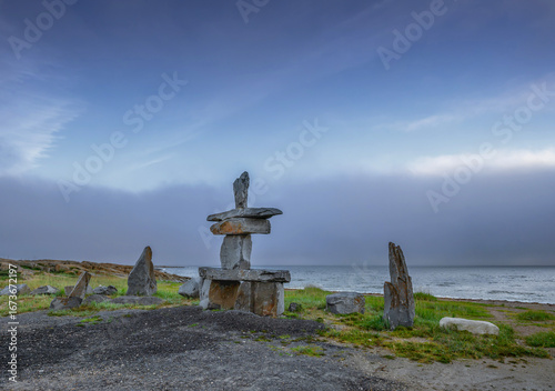 Sunrise over an Inuksuk (inukshuk) on the shore of Hudson Bay at Churchill, Manitoba, Canada