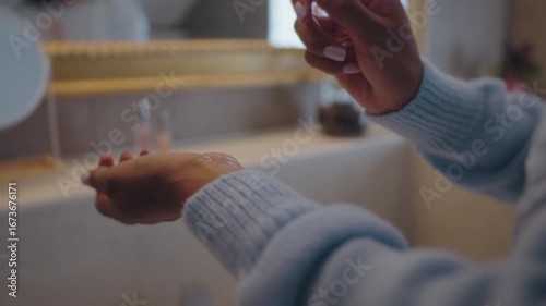 Close Up of Latina Woman's Hands Applying Perfume During Beauty Routine