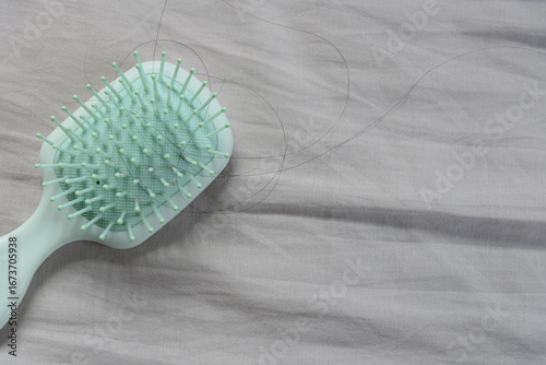 Fallen hair on a cloth with a hairbrush, showing the hair loss problem.
