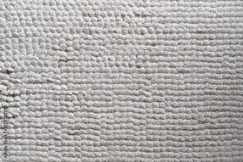 Close-up of a textured gray rug.