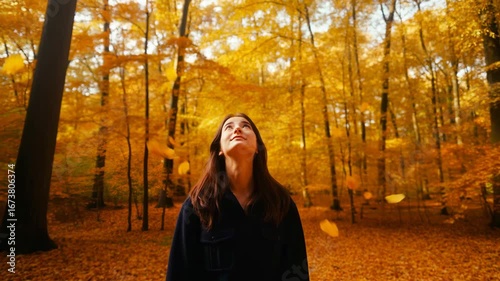 Woman walks alone into deep autumn forest a journey of self discovery she follows a path to find herself this beautiful solitude represents personal growth a new beginning