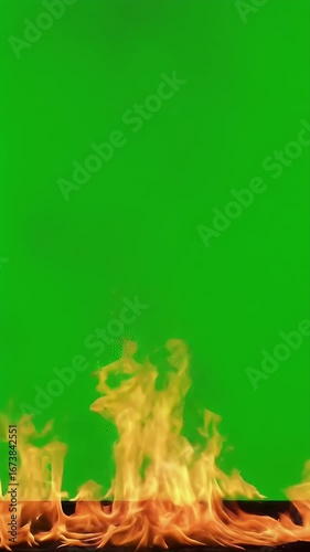 Realistic fire flames burning on a vibrant green screen background, perfect for visual effects and compositing.