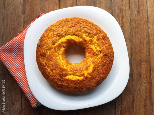 simple cornmeal and corn cake on a wooden background seen from above