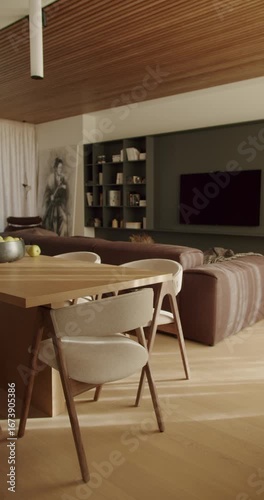 Modern living room interior with wooden furniture, comfortable sofa, dining table, and stylish decor. Natural light illuminates the space, creating a cozy and inviting ambiance.