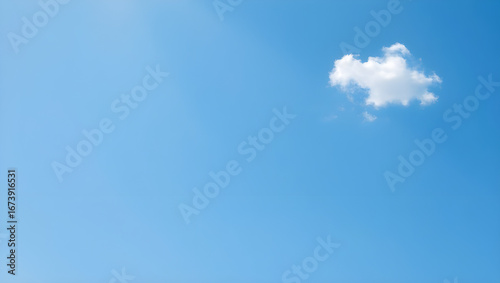Fototapeta Naklejka Na Ścianę i Meble -  Serene blue sky canvas with a single cloud drifting peacefully in the bright sunny day atmosphere