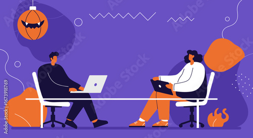 Two colleagues work on laptops at an office desk, highlighting remote collaboration or a seasonal project during Halloween. Perfect for business, tech, or holiday themes.