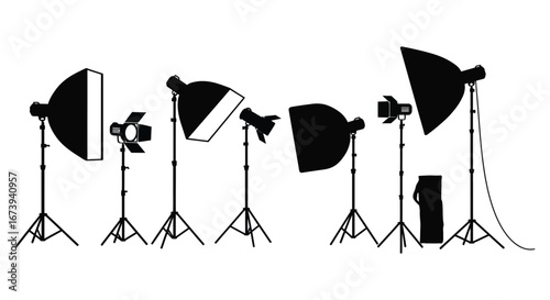 Various photography studio lights and reflectors on stands and tripods