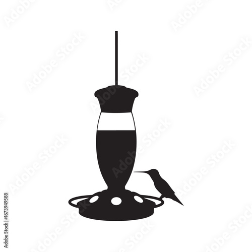 Silhouette of a Hummingbird Drinking from a Hummingbird Feeder in Black and White