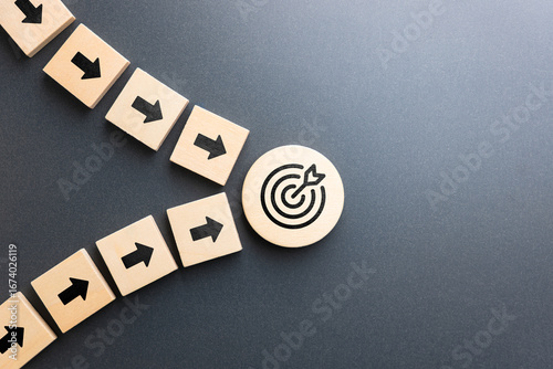 фотографія Wooden arrows from multiple directions converging toward a target icon symbolizi