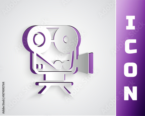 Paper cut Retro cinema camera icon isolated on grey background. Video camera. Movie sign. Film projector. Paper art style. Vector