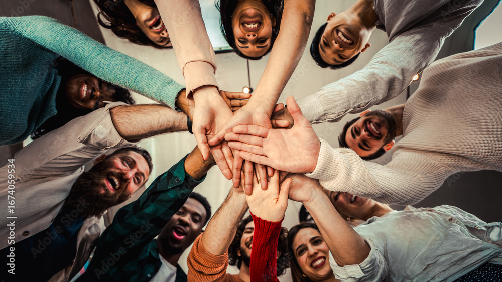 Obraz premium Young happy people stacking hands together outcoor - Community of multiracial international people supporting each other - Diverse culture
