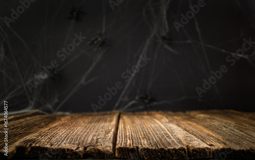 Halloween background. Old wooden table with dark background. Halloween table. Empty space. Place for product.
