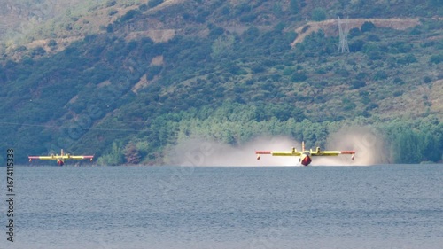Two Italian seaplanes (CL-415) perform a water-collection maneuver at the Bárcena reservoir to help extinguish the forest fires in Galicia and El Bierzo