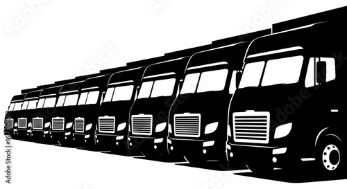 A line of black semi-trucks are parked in a row, viewed from a low angle.
