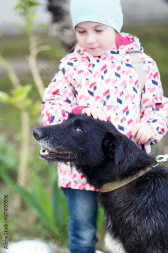 portrait of a black dog shorthaired pointer wirh a girl