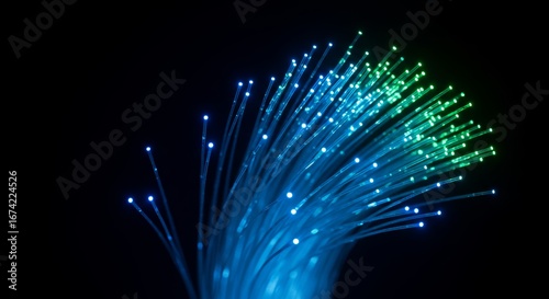 Fiber optic strands radiating blue and green light against black backdrop