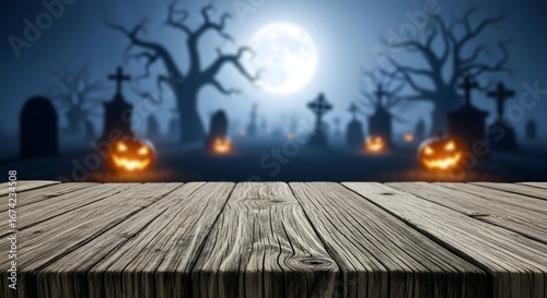 Empty wooden table top with a spooky Halloween night background of a cemetery with glowing pumpkins and a full moon. For product display