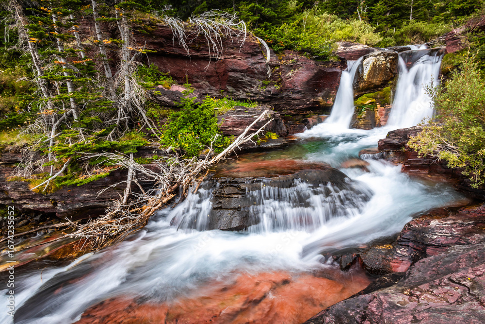 Fototapeta premium Baring Creek waterfalls on Siyeh Pass Trail in Glacier National Park