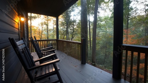 Secluded cabin porch featuring rocking chairs overlooking a vibrant autumn forest at sunset