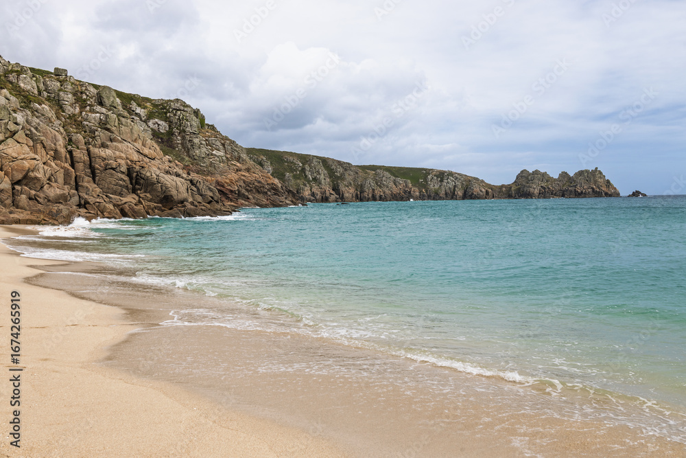 Fototapeta premium Porthcurno Beach, Cornwall UK with wide golden sand and clear Atlantic water
