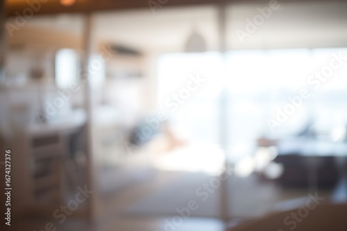Blurred view through a glass door of a bright interior space