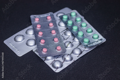 Loaded blister strip for pills on black background.