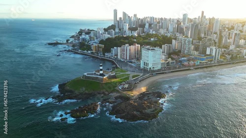 Aerial View of Barra Lighthouse on the Rock in the Ocean With Salvador Cityscape During Sunrise in Bahia State of Brazil