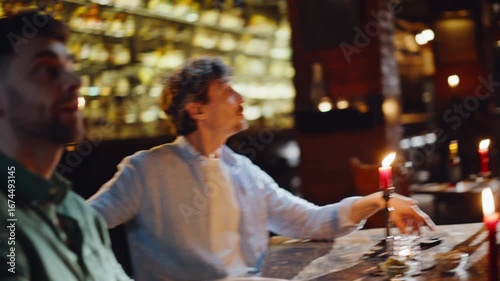 Romantic people blind date in cozy cafe atmosphere with glowing candle closeup.