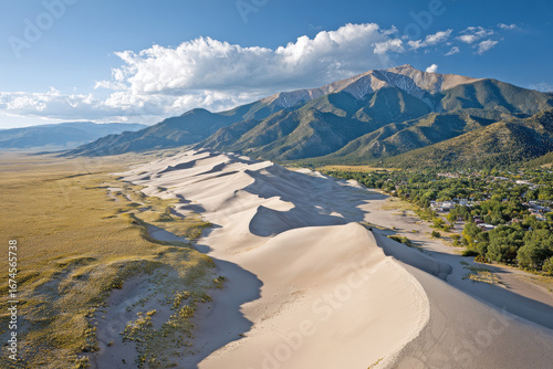 breathtaking aerial view captures stunning contrast of vast golden sand dunes stretching endlessly