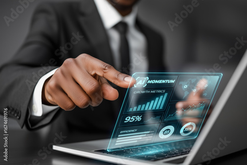 Businessman is interacting with holographic charts displaying growth metrics, leveraging artificial intelligence on a laptop for enhanced business performance and strategic decision making