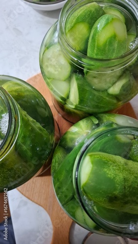  green cucumbers, pickled in glass jars, healthy food, delicious food