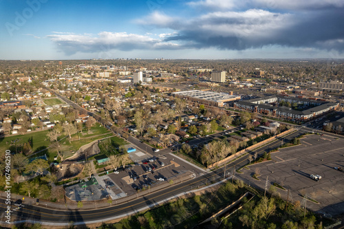 Aerial view of highway interchange and suburban development in Englewood with Denver skyline visible in distance, Colorado, USA