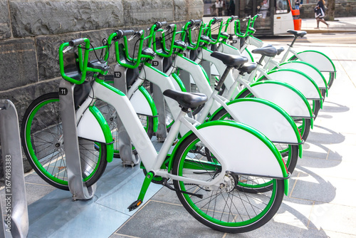 Bicycles parked at a rental station in Norway during a sunny day