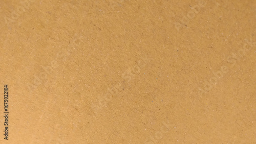 Background of brown kraft paper or cardboard texture. Abstract pattern of beige rough carton, old paper sheet.