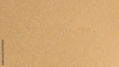 Background of brown kraft paper or cardboard texture. Abstract pattern of beige rough carton, old paper sheet.