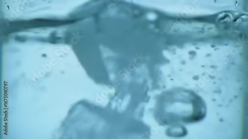 Ice cubes dissolving in water