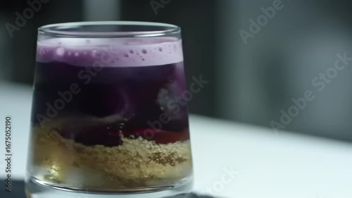 Layered purple and brown beverage in glass