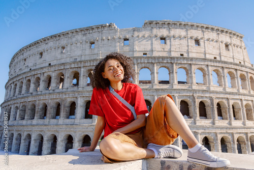 Canvas Print A very cheerful traveler poses happily in front of the iconic Colosseum in beaut