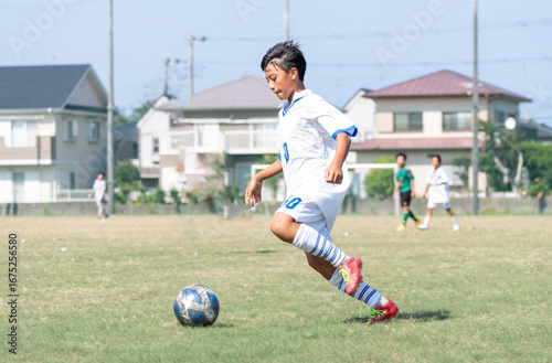 サッカーの試合をする中学生の男の子