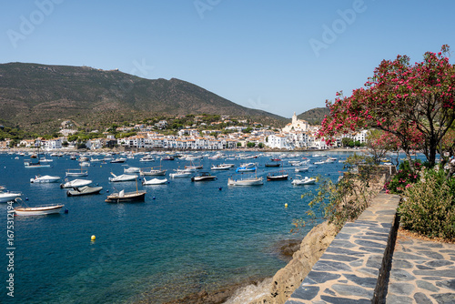 White boats are floating peacefully in the harbor of cadaques, a picturesque town on the costa brava in catalonia, spain, on a beautiful summer day