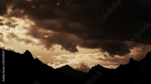 Timelapse of Mountain Peaks Silhouette with Dynamic Sepia-Toned Cloudy Sky