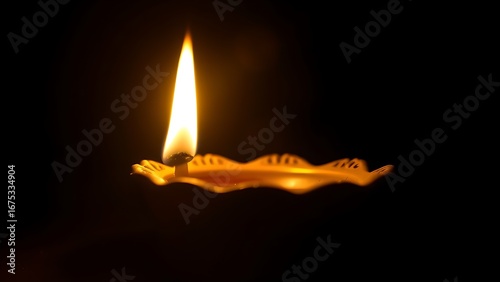 A golden oil lamp glows warmly against a dark backdrop, its flickering flame creating a cozy atmosphere.