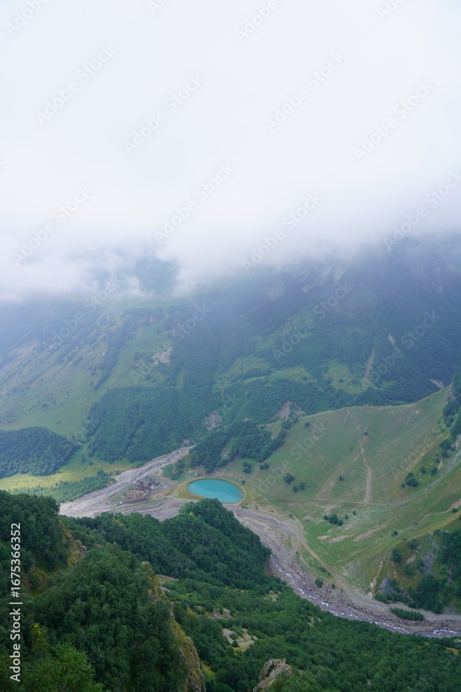 Fototapeta premium A natural landscape with a small blue lake located in the mountains.