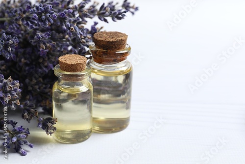 Obraz na plátně Bottles of herbal lavender oil on white background